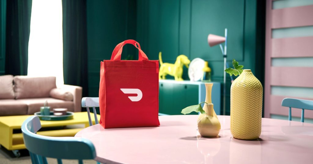 DoorDash bag sitting on a dining room table