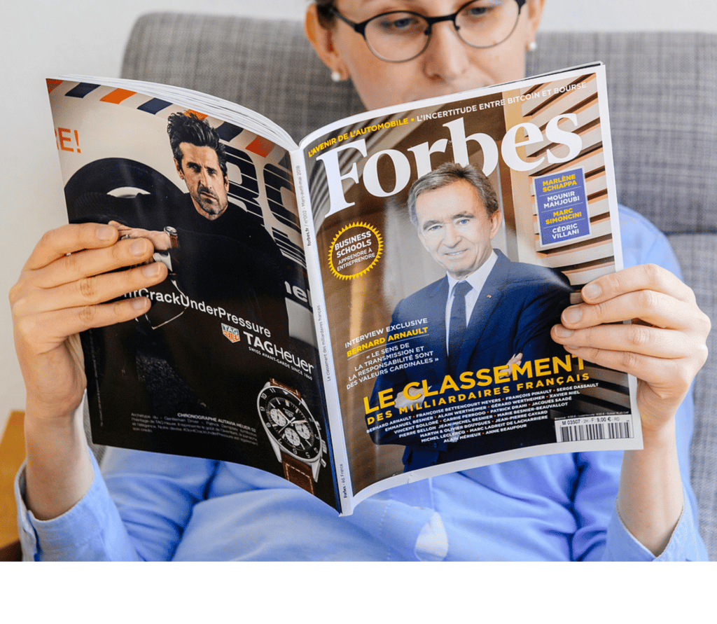 woman reading a Forbes magazine