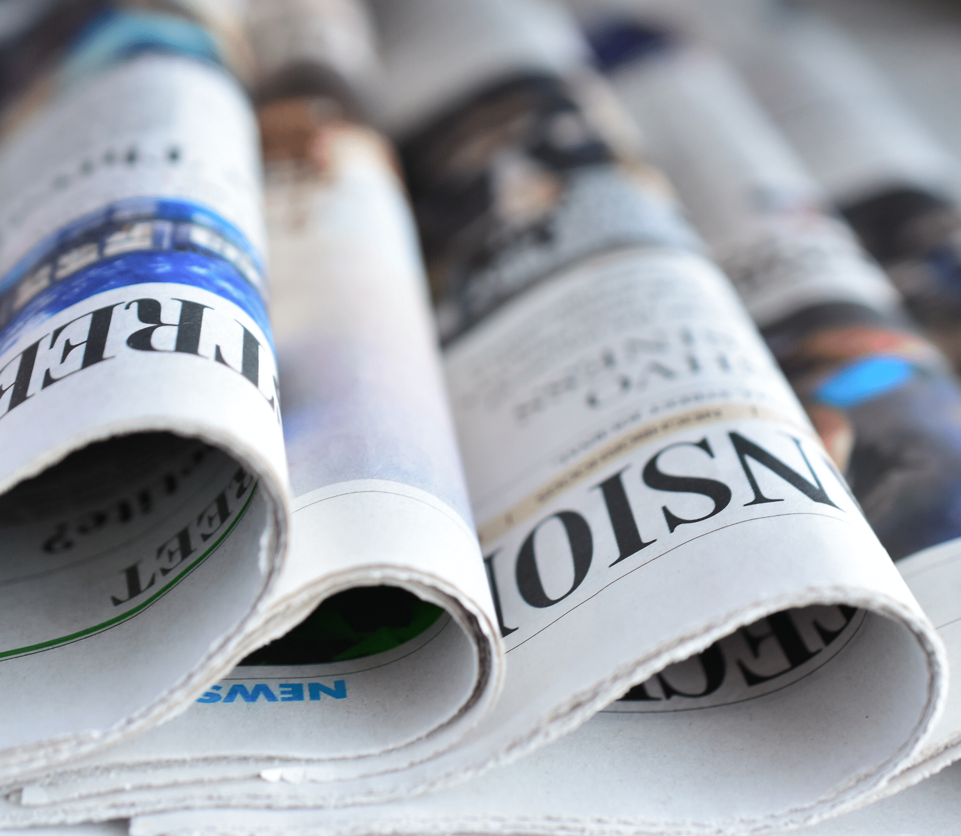 Newspapers on counter showing subscription business headlines