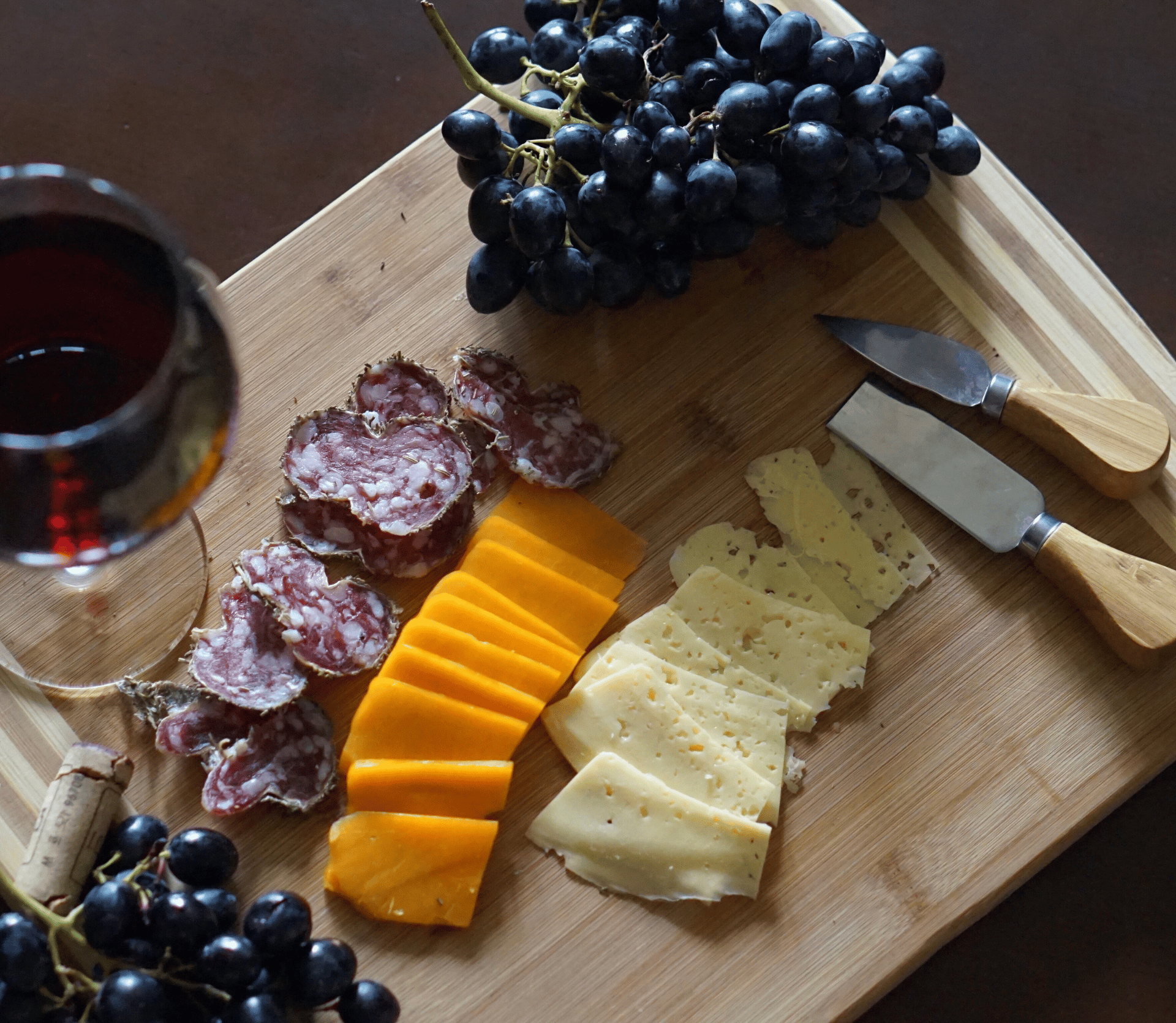 A glass of red wine with a charcuterie board, representing FOOD & WINE magazine's new Classic Insider subscription service