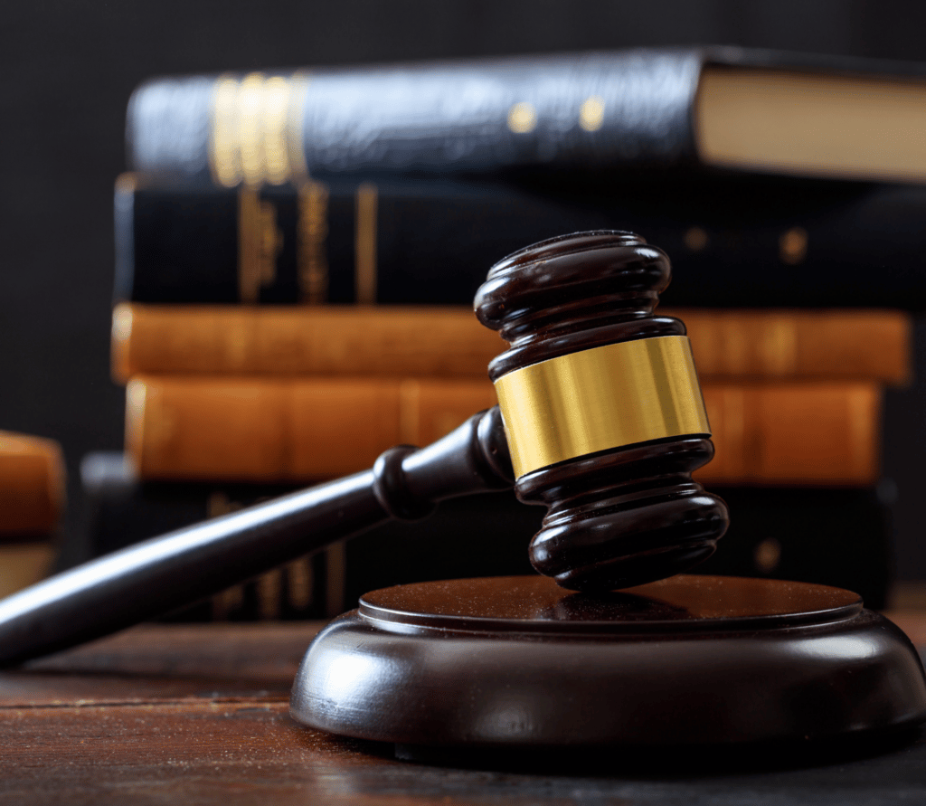 Gavel with law books displayed in the background