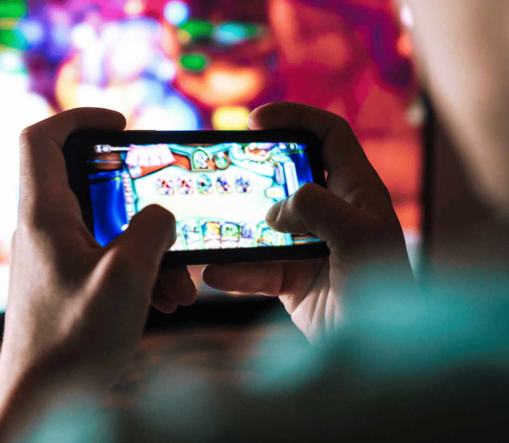 Young man plays mobile game on smartphone