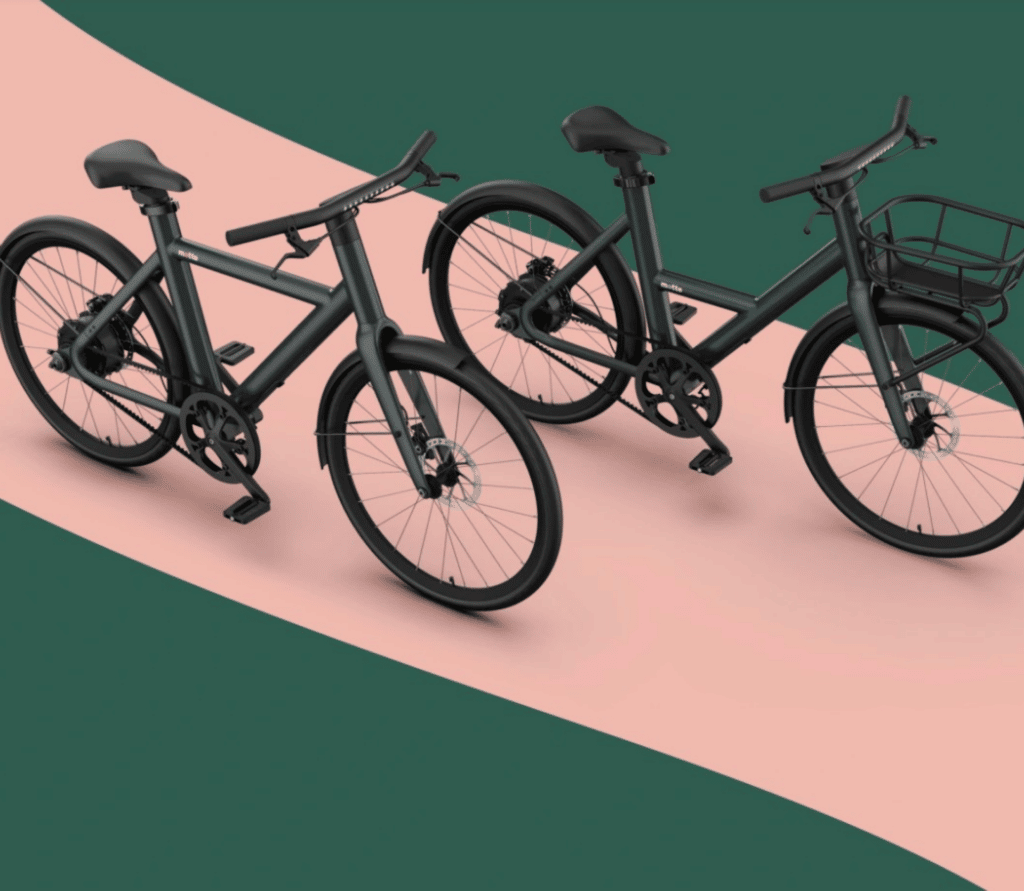 Two styles of Motto ebikes on a pink and green background