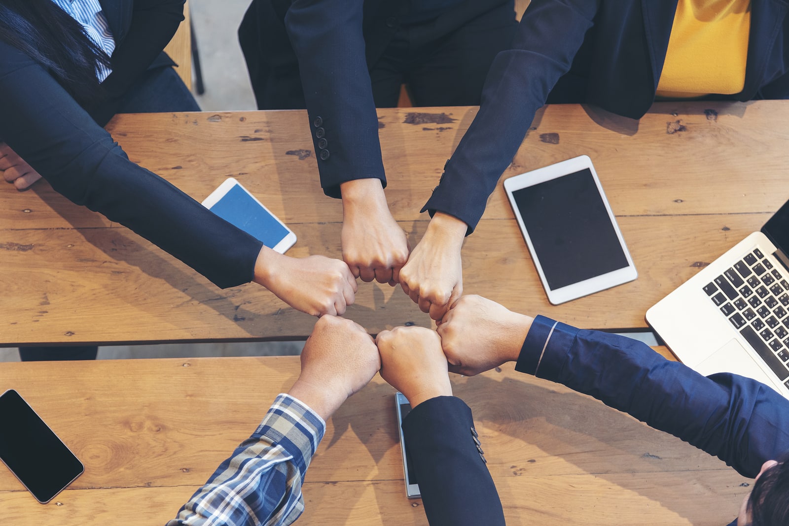 Group of diversity people fist bump holding hands together power of tag team. Teamwork Multiethnic people group working togetherness. Business people team holding hands successful. Business meeting