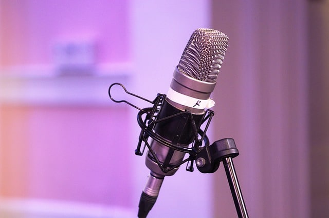 Podcast microphone on a stand on a purple background