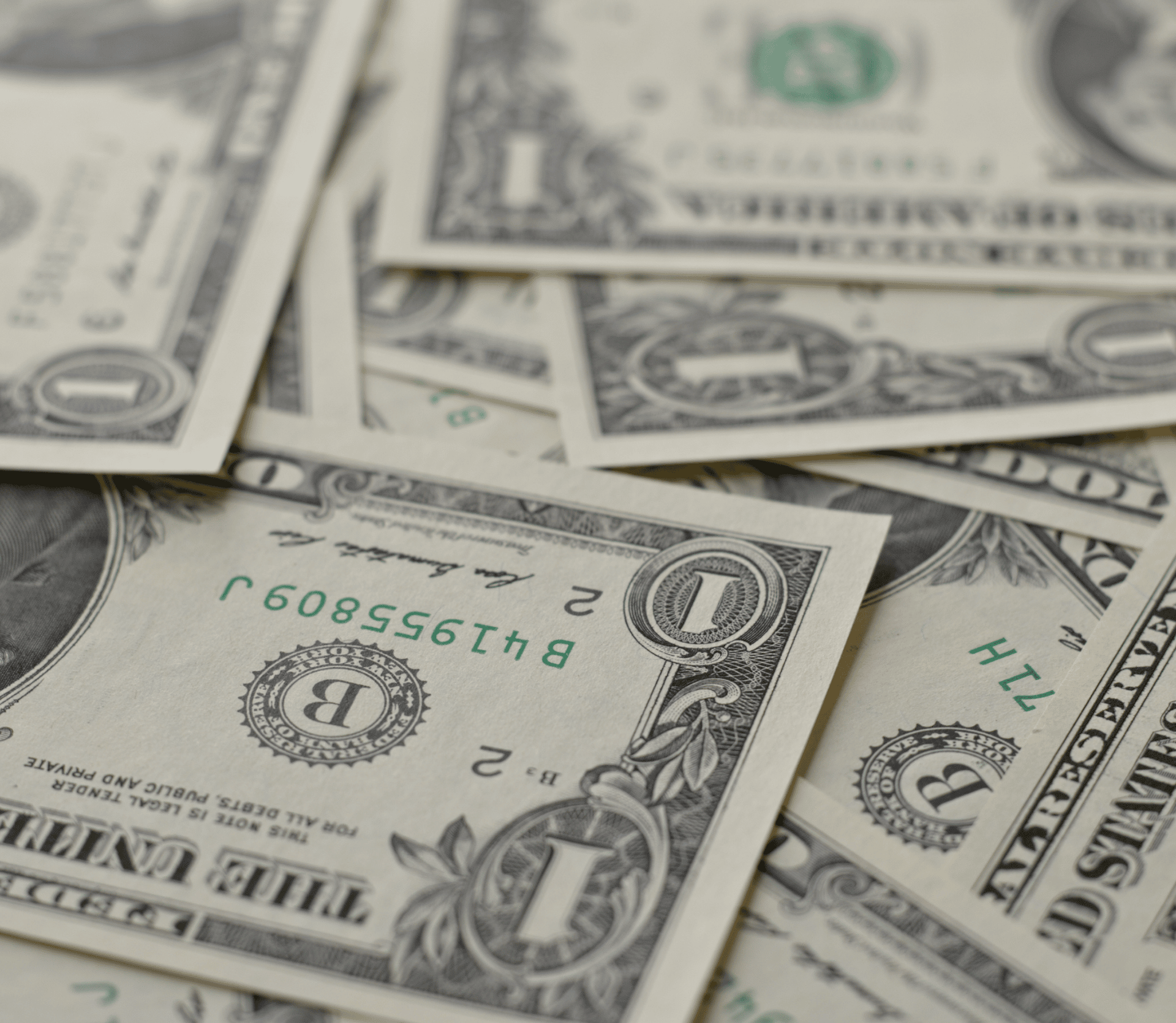 Dollar bills scattered on a desk