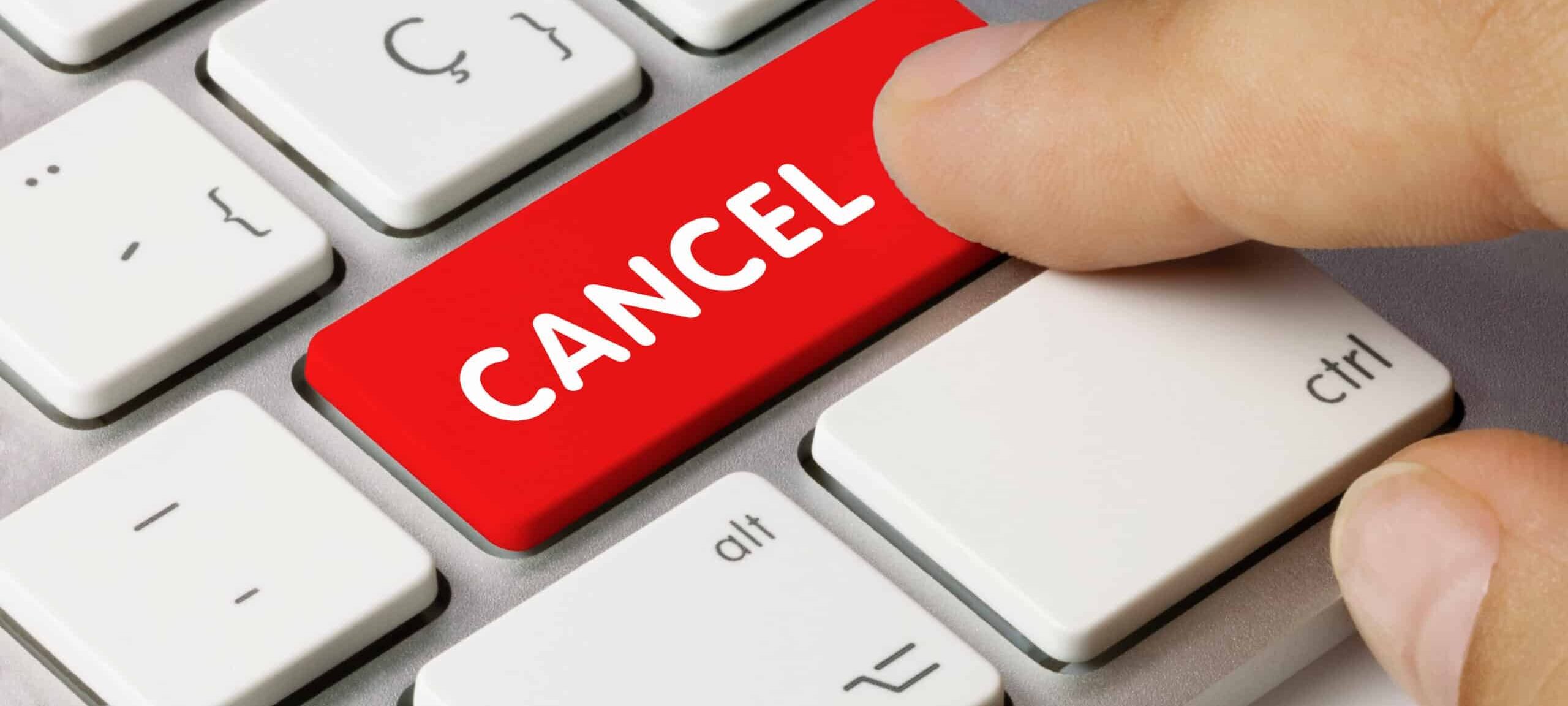Consumer clicking a red Cancel key on their keyboard.