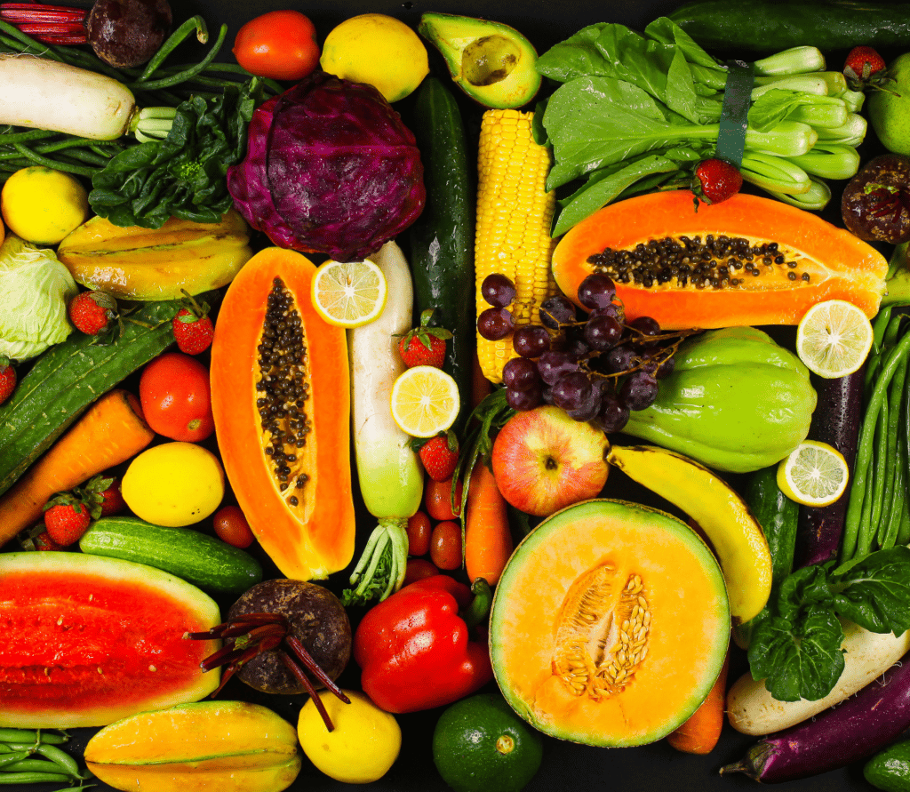 A collage of fresh fruits and vegetables displayed on a table