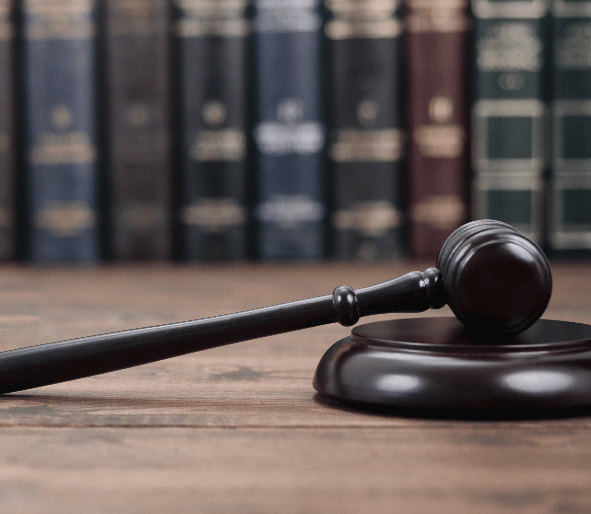 Judge's gavel on desk in front of law books