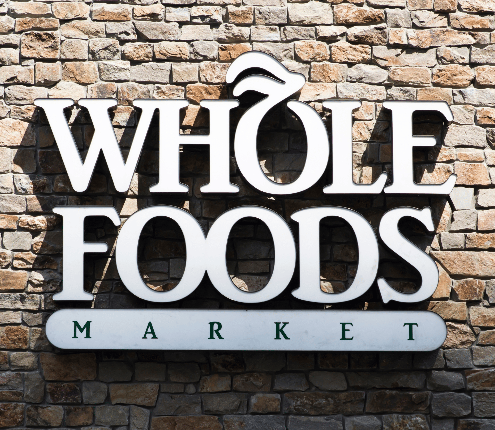 Whole Foods Market logo on the side of the grocery store