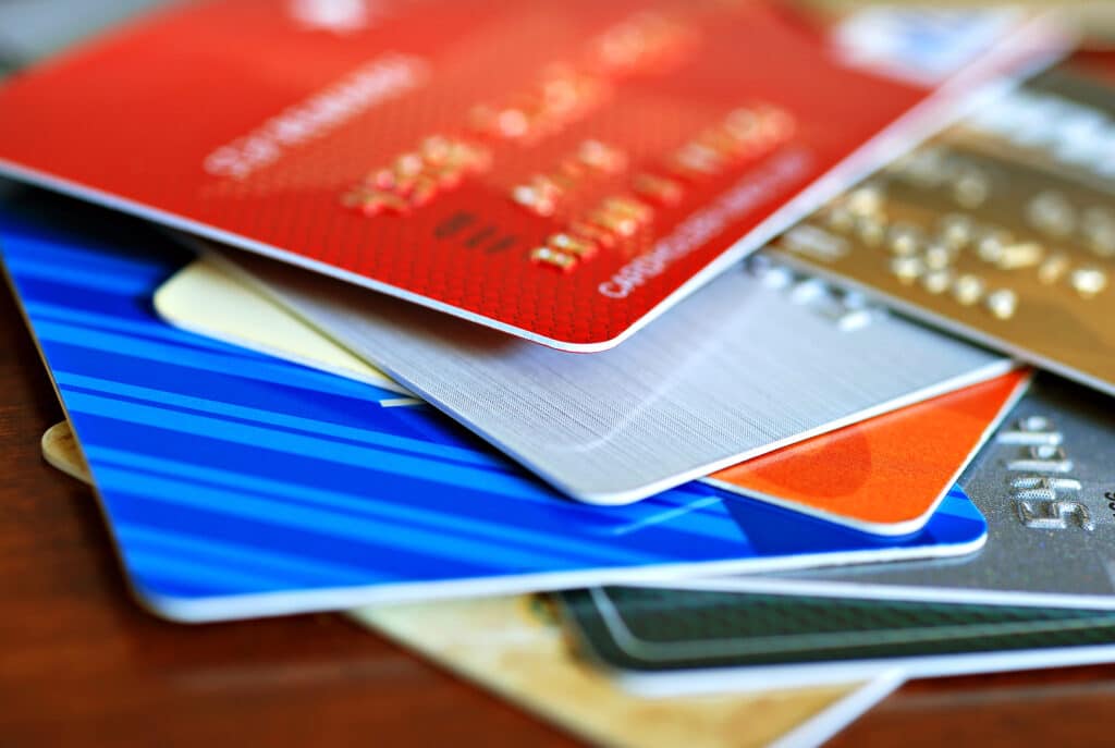 Colorful stack of credit cards and shopping gift cards.