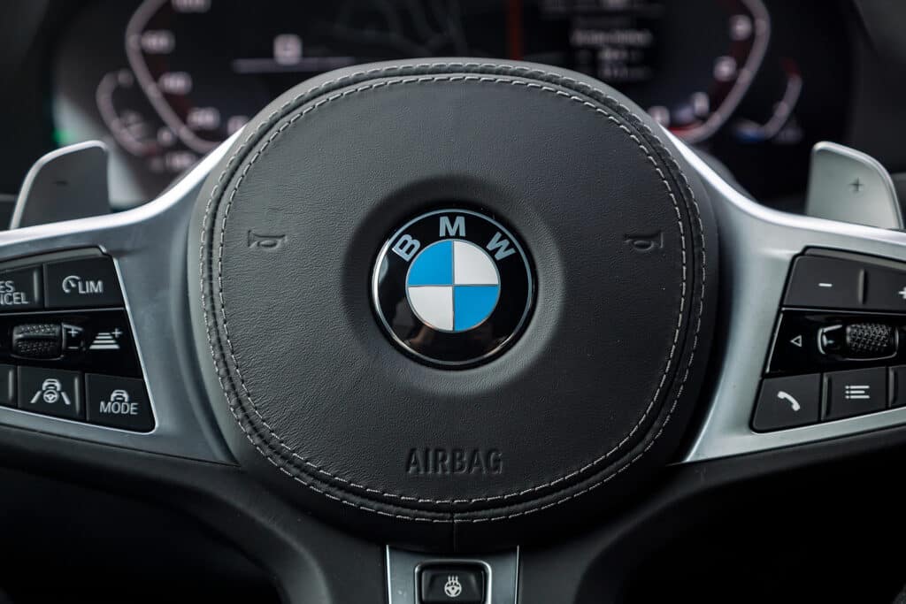 BMW X5 M, vehicle interior of a modern car with voice control button and logo BMW