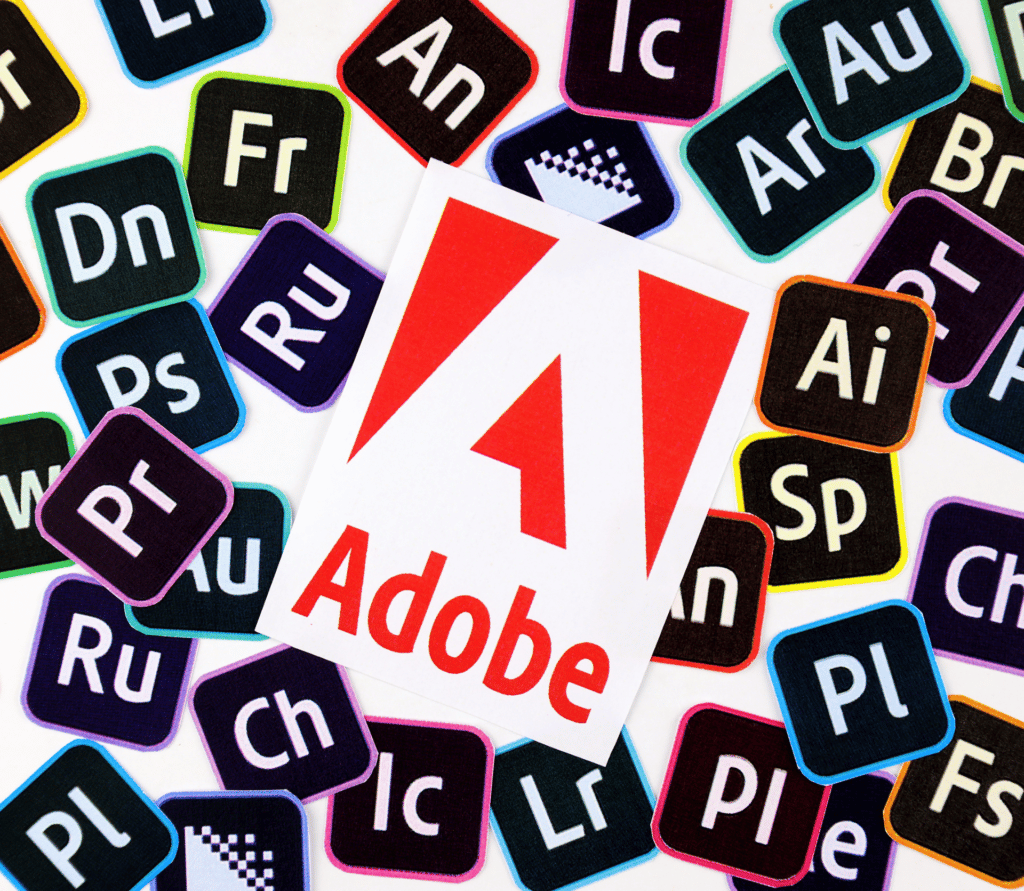 Adobe logo sitting on top of numerous Adobe product logos