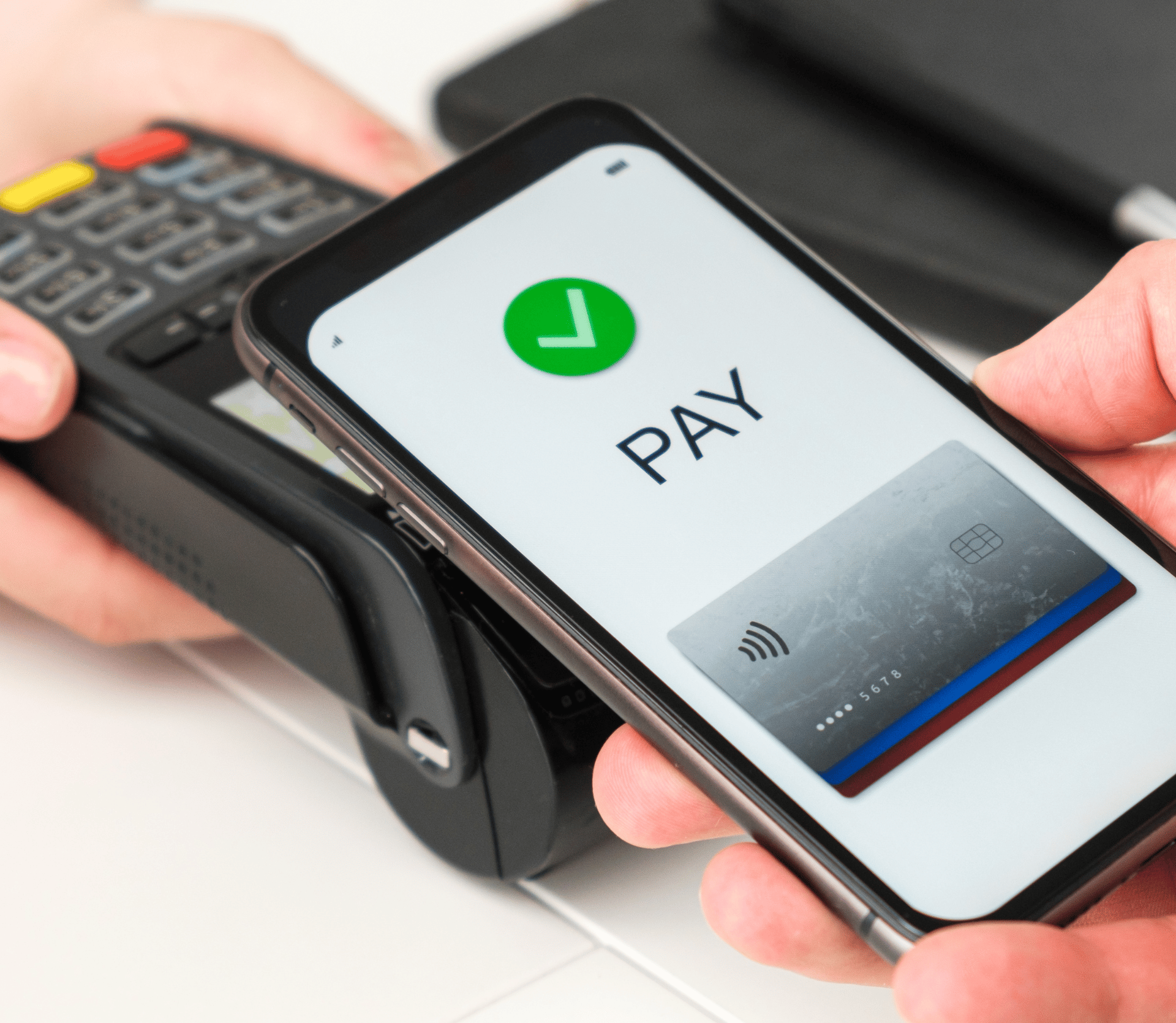 Customer uses smartphone to make a contactless payment at a merchant