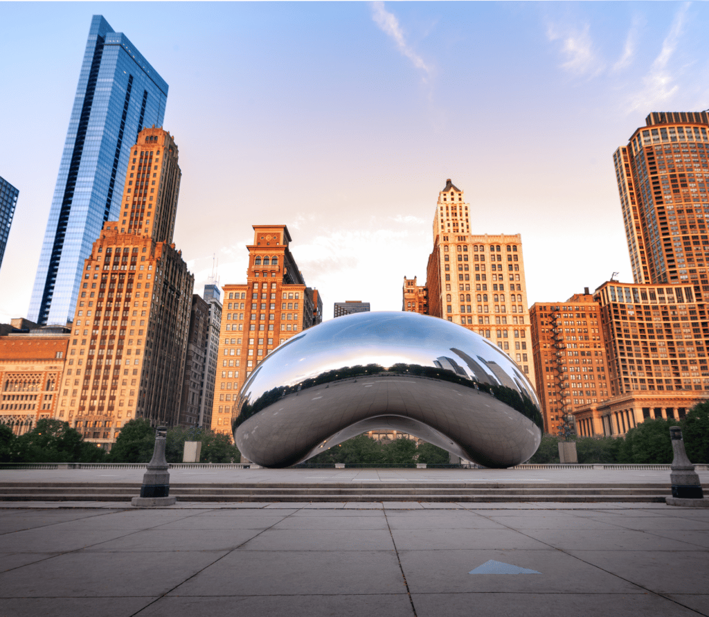 The Chicago bean landmark in Chicago's Millennium Park with skyscrapers in the background