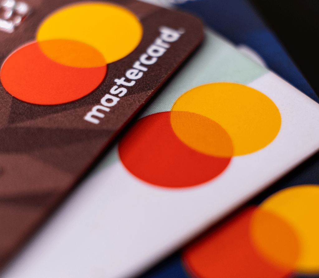 Three Mastercard credit cards fanned out on a desk