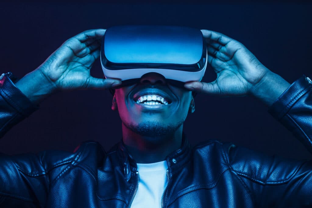 African man wearing virtual reality VR headset having great fun