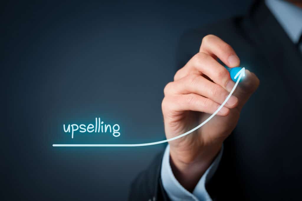 Upselling on-line (e-shop) marketing concept. Sales technique for more profitable sale. Businessman draw growing profit graph thanks upselling.