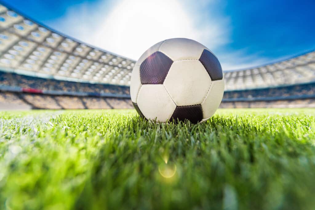 Close up view of soccer ball on grass on soccer field stadium