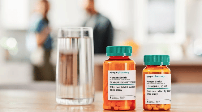 Two Amazon Pharmacy prescription bottles on a kitchen counter next to a glass of water.