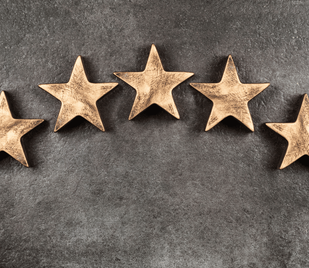 Five wooden stars in an arch on a gray background