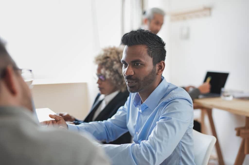 Multiracial business people working inside modern bank office using computer laptop