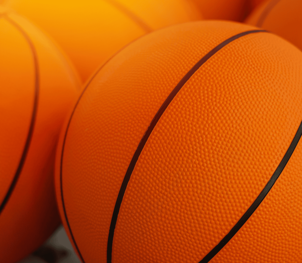 Orange basketballs arranged on a basketball court