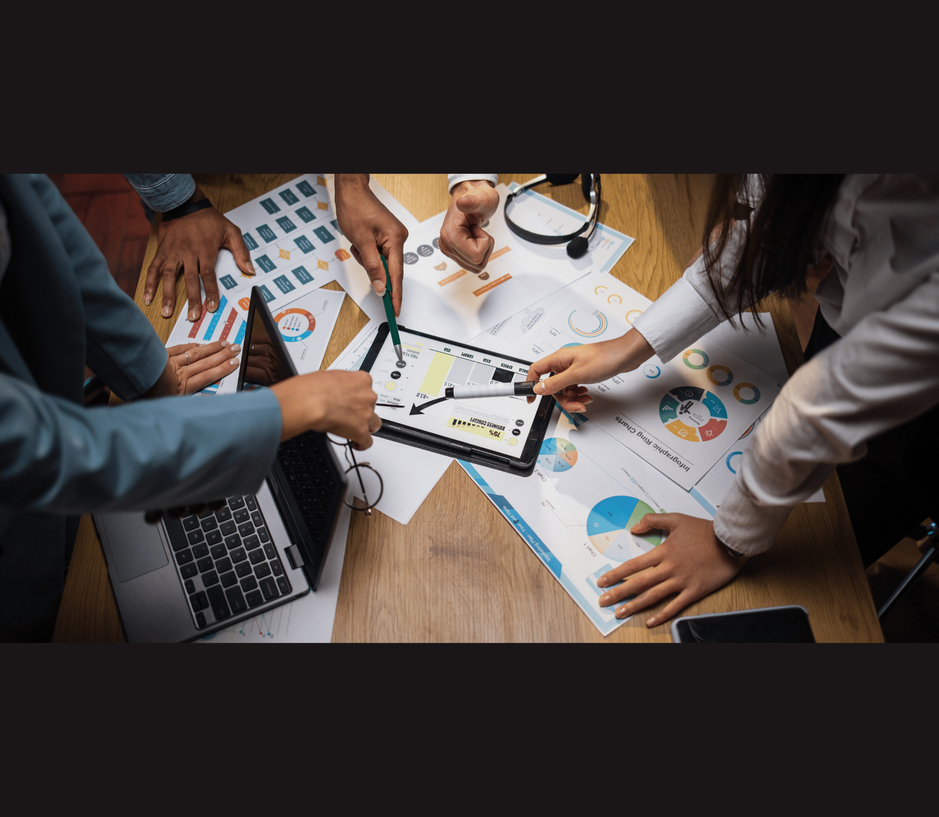 Multi ethnic brokers analyzing financial statistic at office