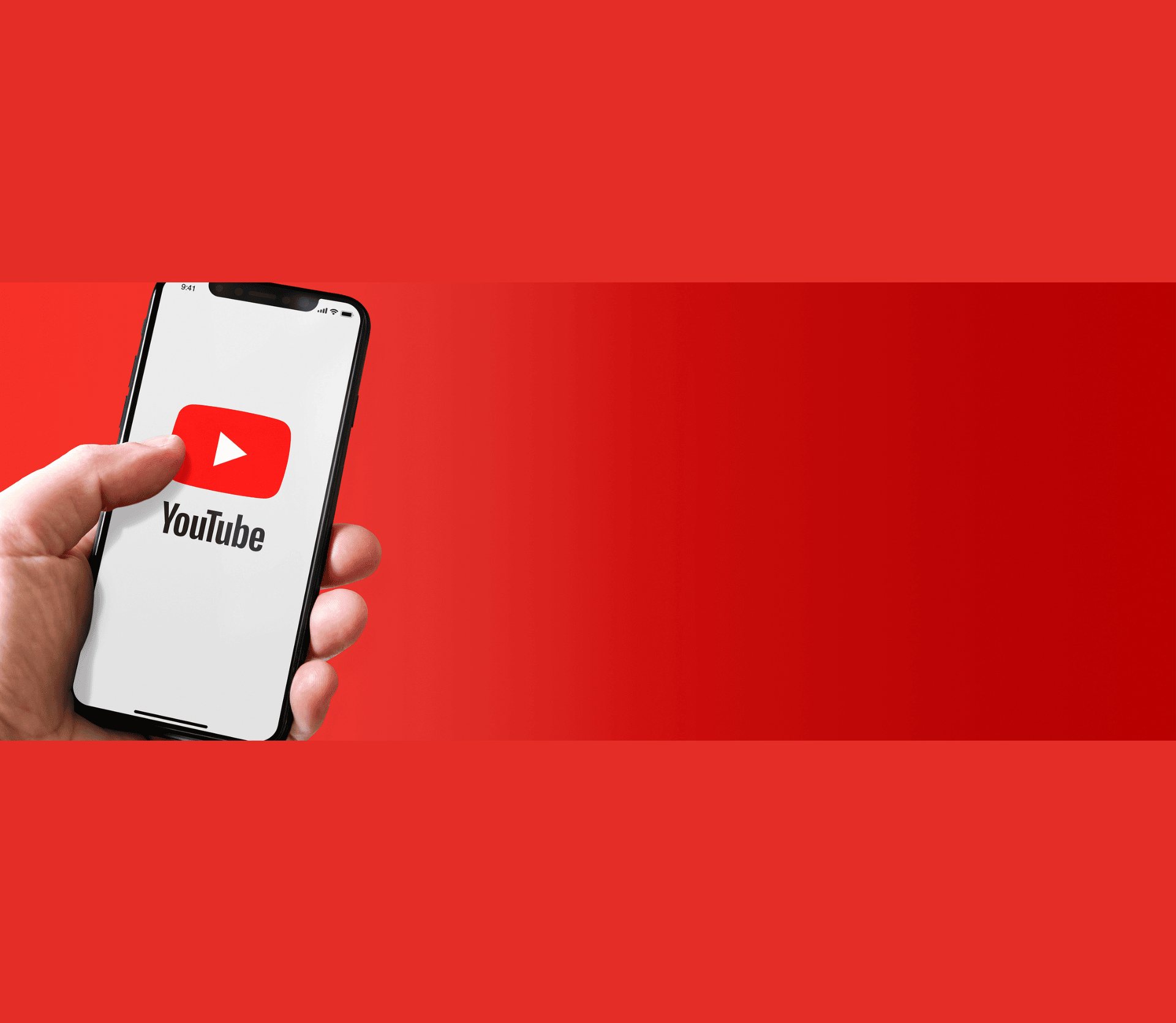 Hand holding iphone smartphone with YouTube logo. Horizontal banner on red background.