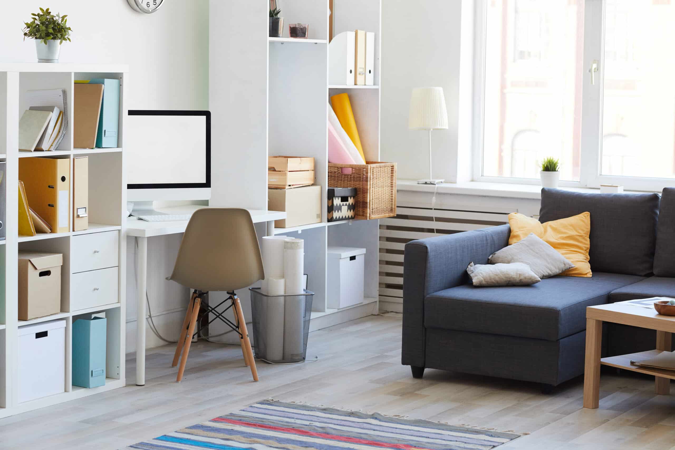 Domestic interion in white and blue with home workplace in living room, copy space