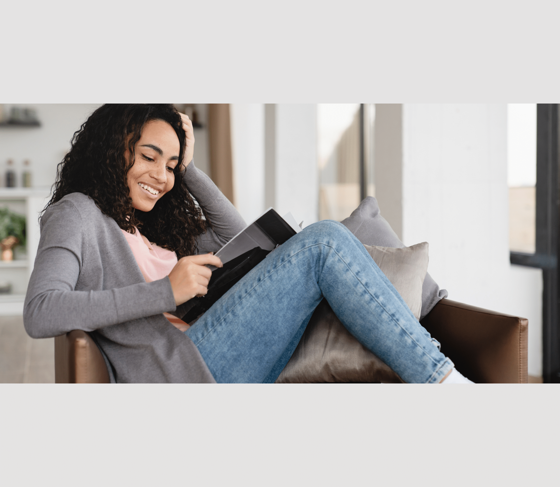 Relaxing resting young african woman freelancer student reading magazine book at home