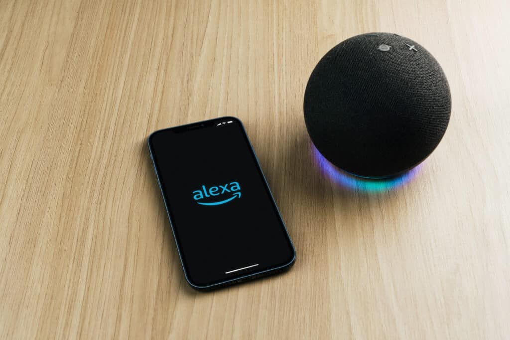 Alexa, Smart speaker and virtual assistant from Amazon company connected to smartphone app. Wooden background. Rio de Janeiro, RJ, Brazil. September 2021.