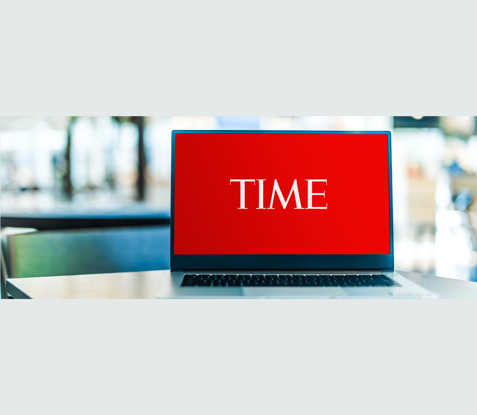 Laptop with TIME logo on red background on a desk in an office