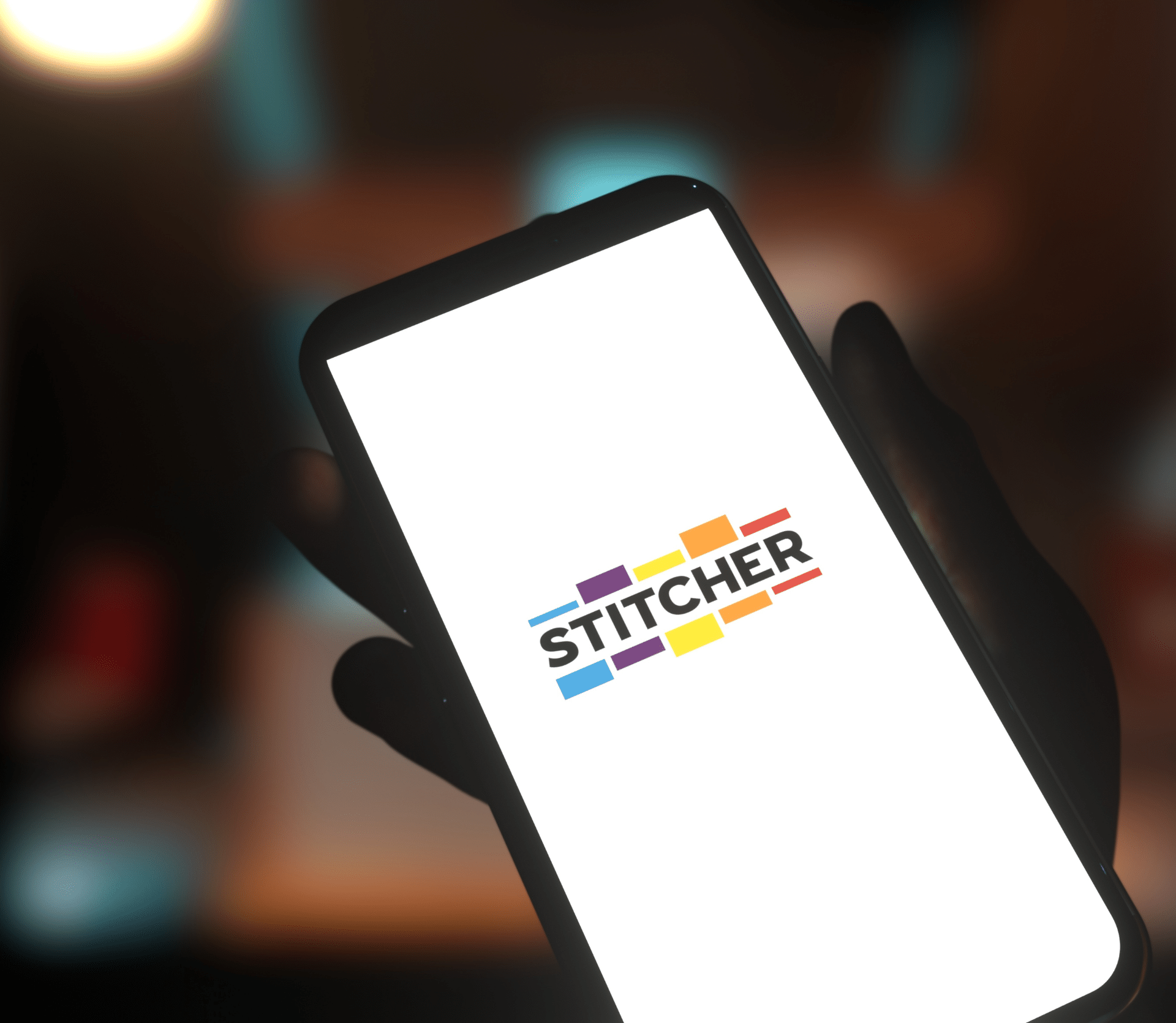 Podcast app Stitcher logo on a smartphone