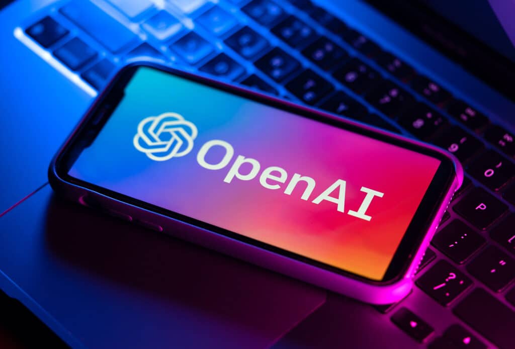 Illustrative editorial of OpenAI logo on smartphone screen on the laptop. Open Ai is an American company that develops machine learning known for AI ChatGPT and DALL-E