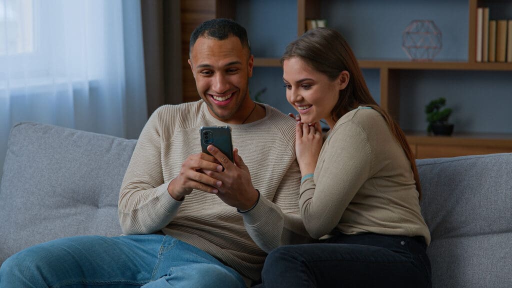 Multiracial couple downloads apps from an app store