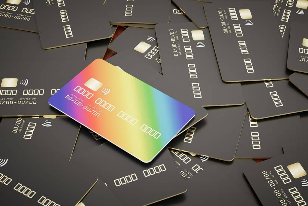 many black credit cards and one multi-colored credit card. 3D render.