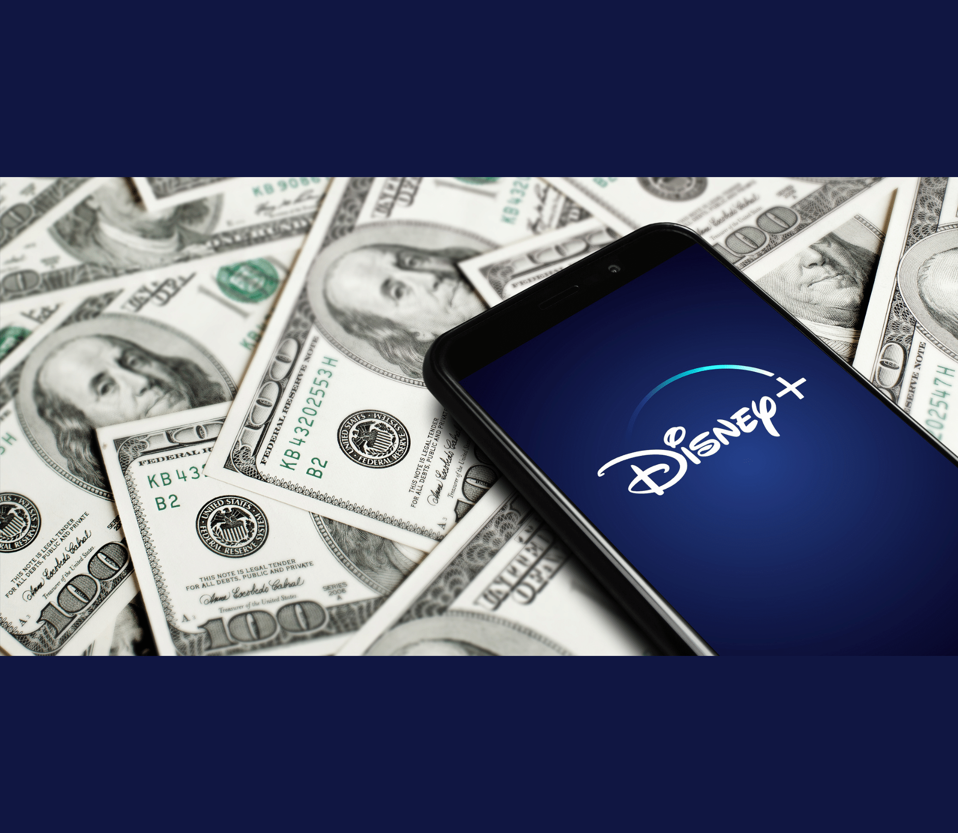 Disney+ logo on smartphone on table with hundred dollar bills