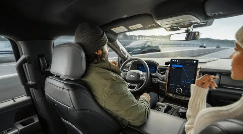 Image of a couple in a Ford SUV enabled with BlueCruise hands-free technology