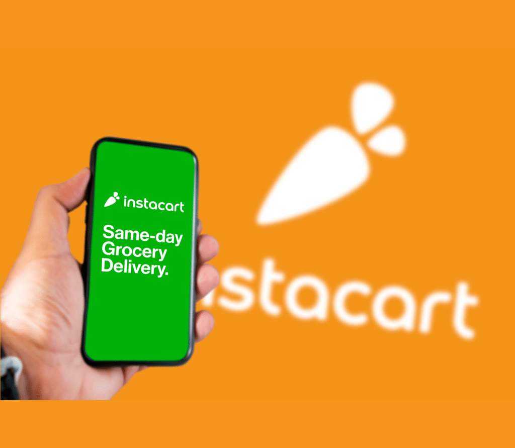 Person holding smartphone with Instacart app in front of orange background with the logo in white