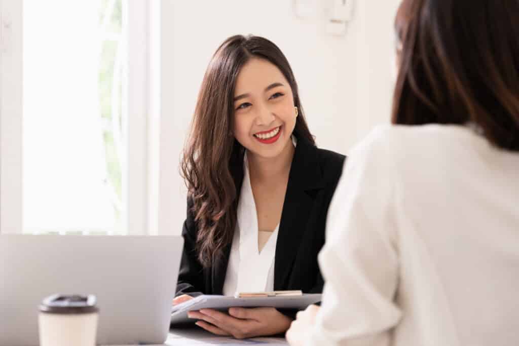 Young Asian woman interviewing another woman